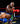 Boxer in red gloves delivering a punch to an opponent in a boxing ring.
