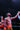 Boxer in red shorts celebrating with a raised fist on a dark background