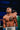 Boxer with tattoos standing in a boxing ring